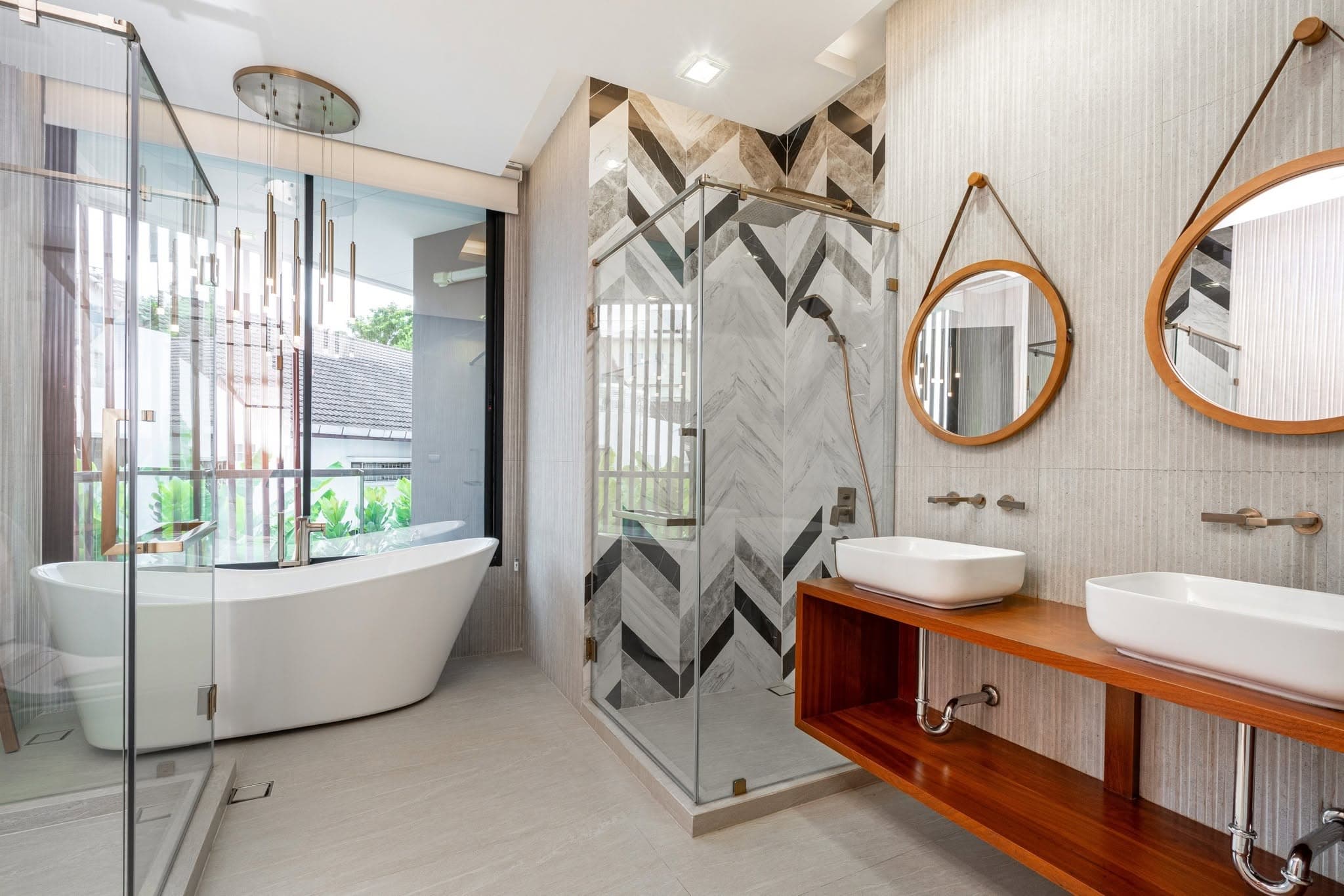 Bathroom with freestanding tub and chevron tiling