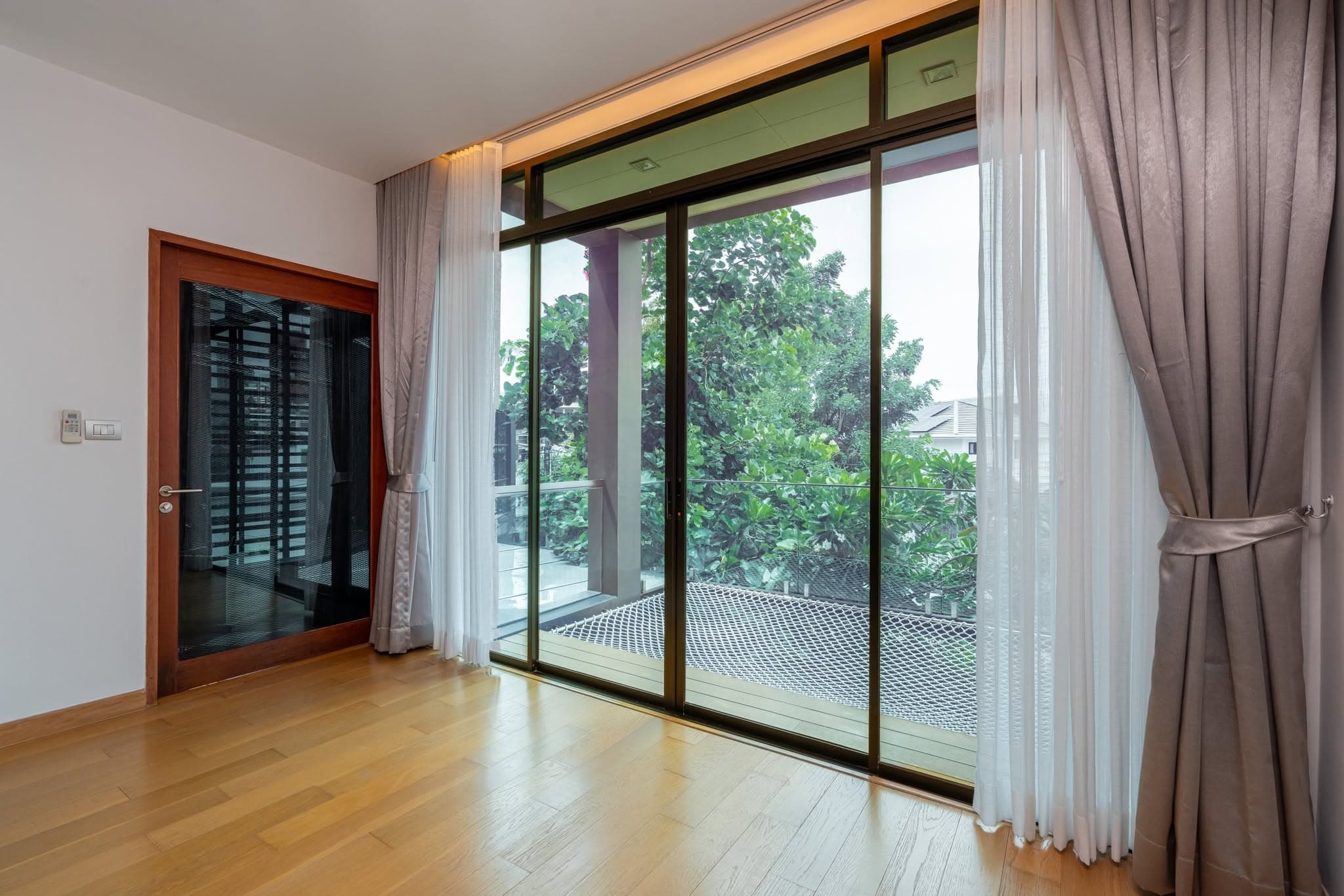 Bedroom with full-height sliding glass doors
